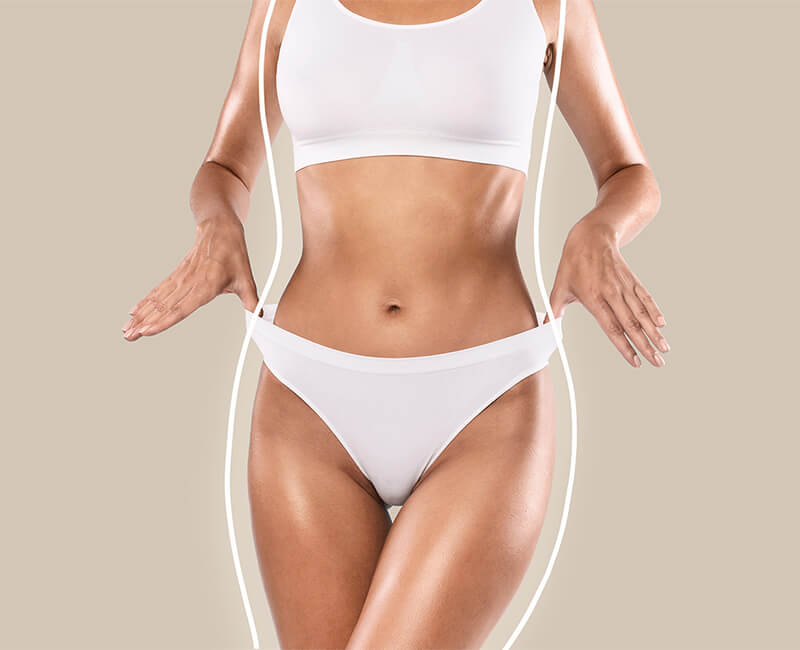 Mid body shot of a curvy woman in white undergarments