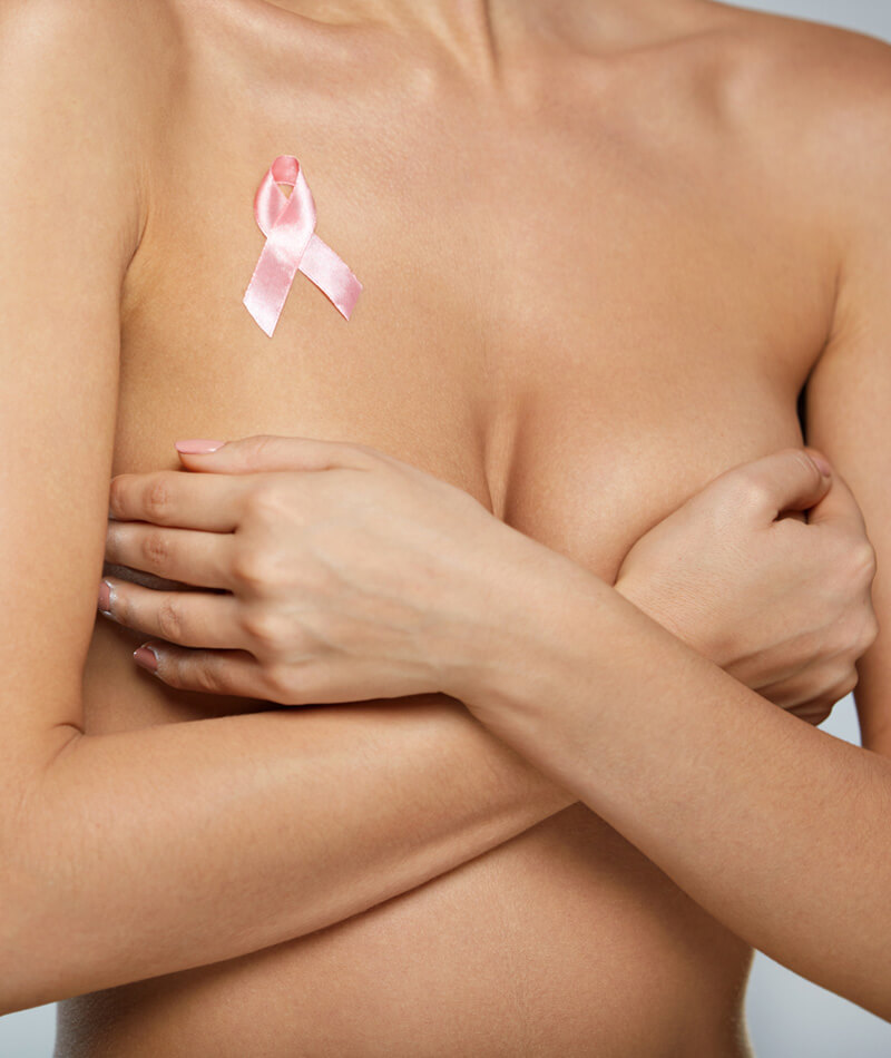 Woman covering breast in bra